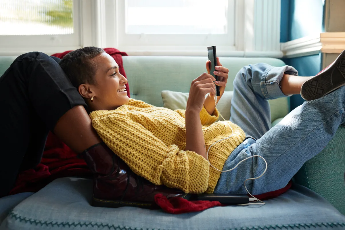 Woman scrolling through media on her phone.